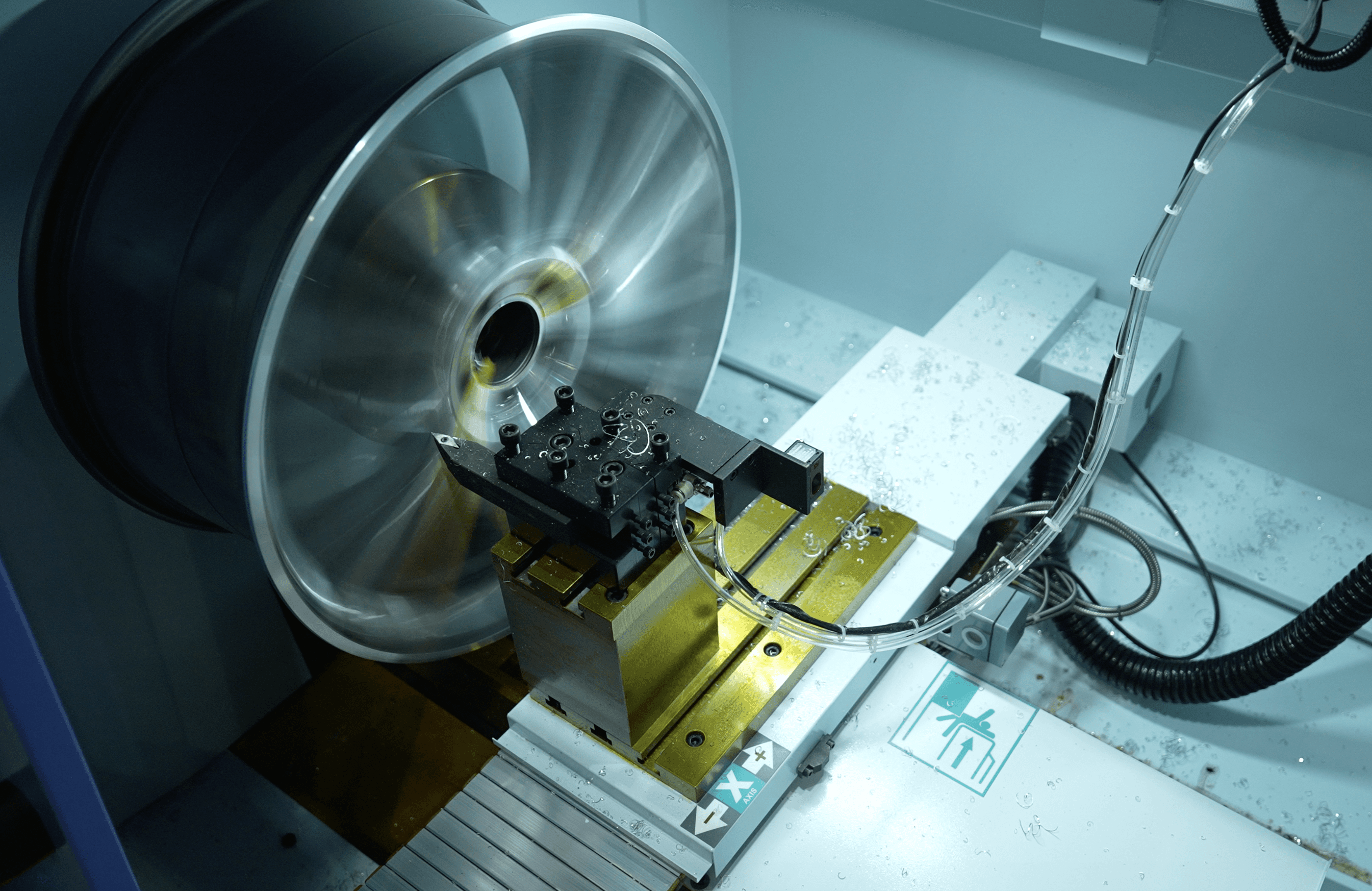 Spacious, luxurious living room with high ceilings, an elegant beige sectional sofa, warm ambient lighting, classical artwork, and rustic architectural elements, featuring an open layout with a view of a mezzanine level.