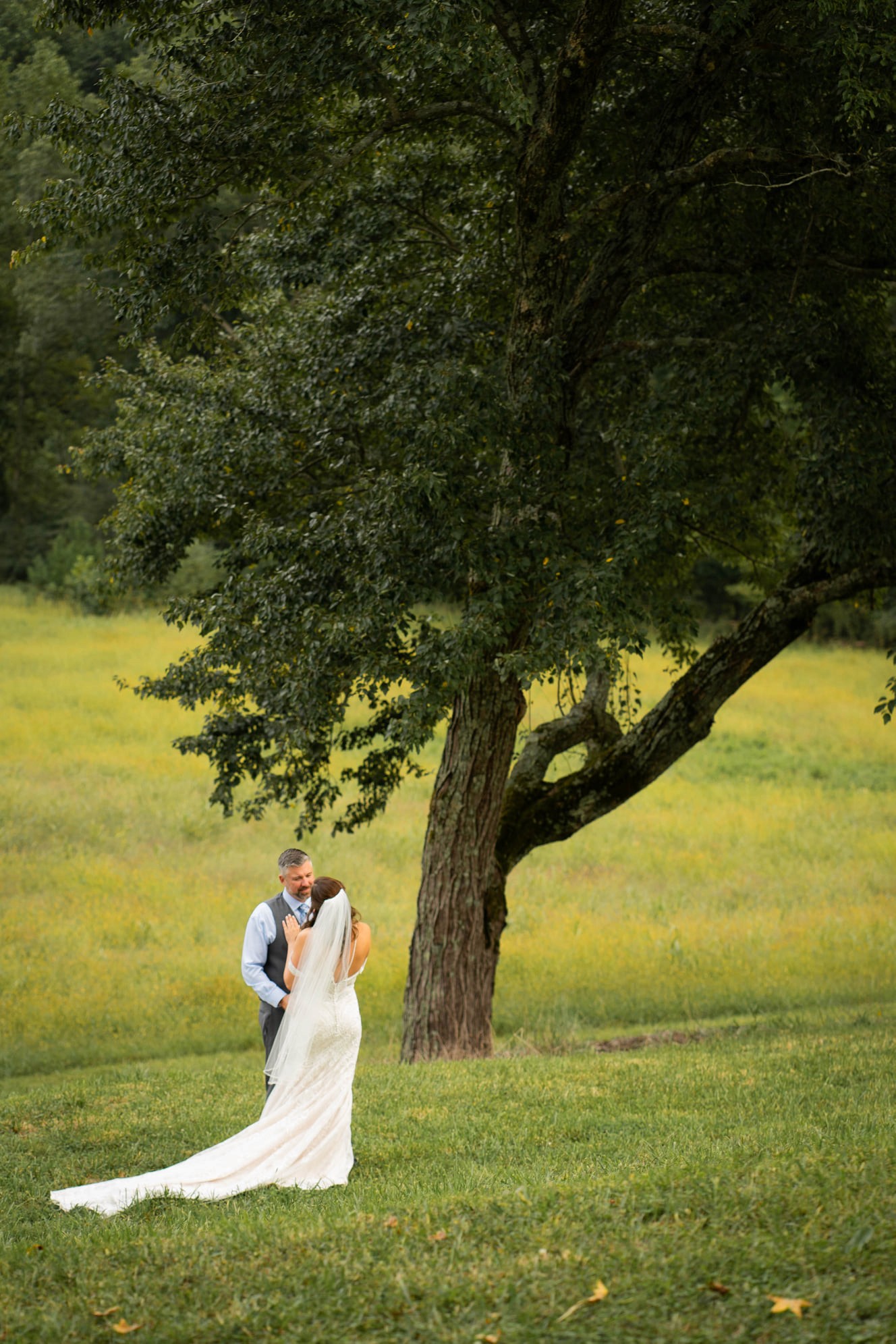 A couple stands closely in an intimate embrace.
