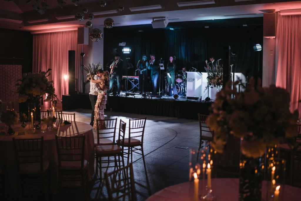 Live band performing in a candlelit reception hall