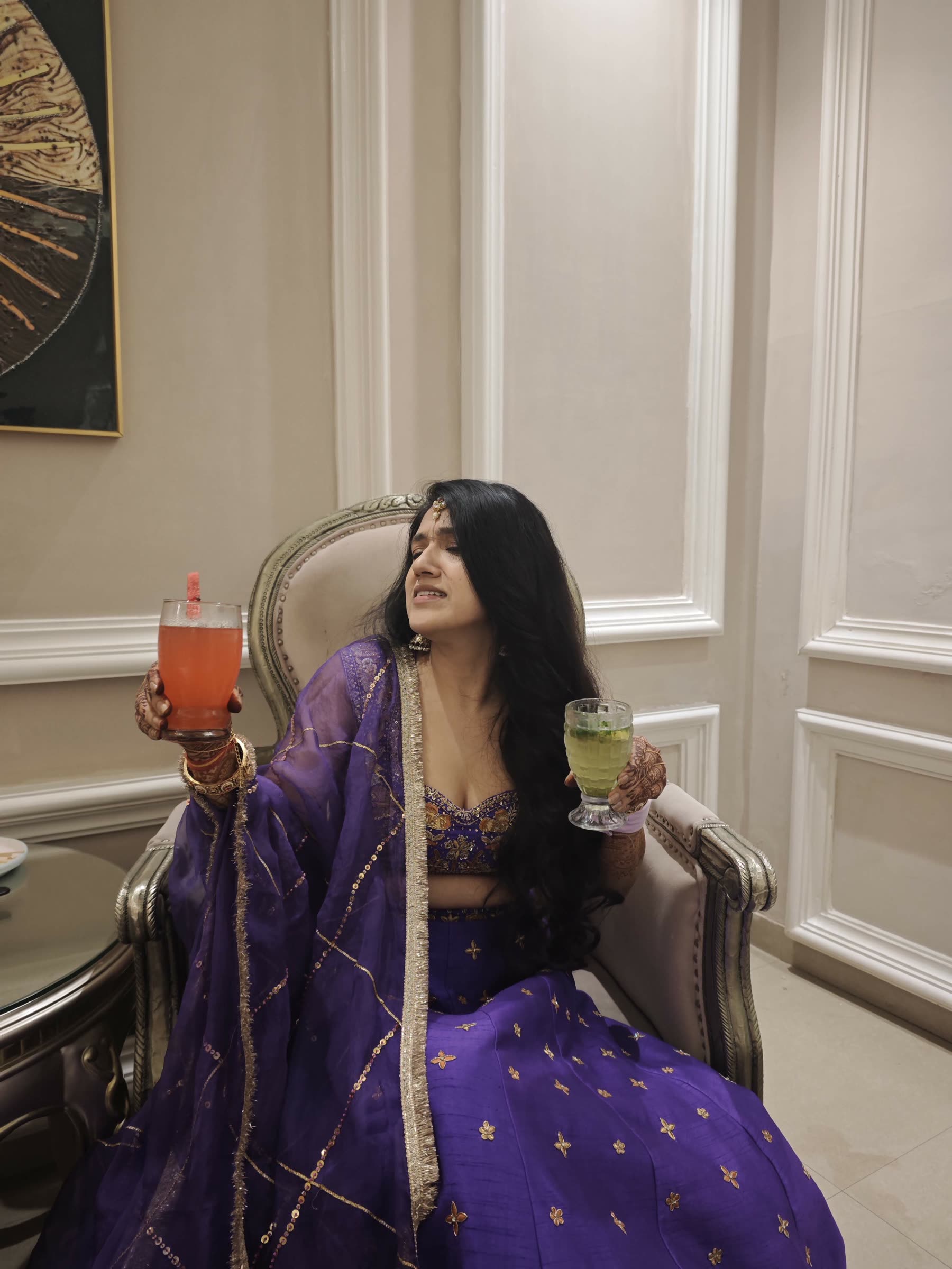 Sarika seated in purple festive clothes