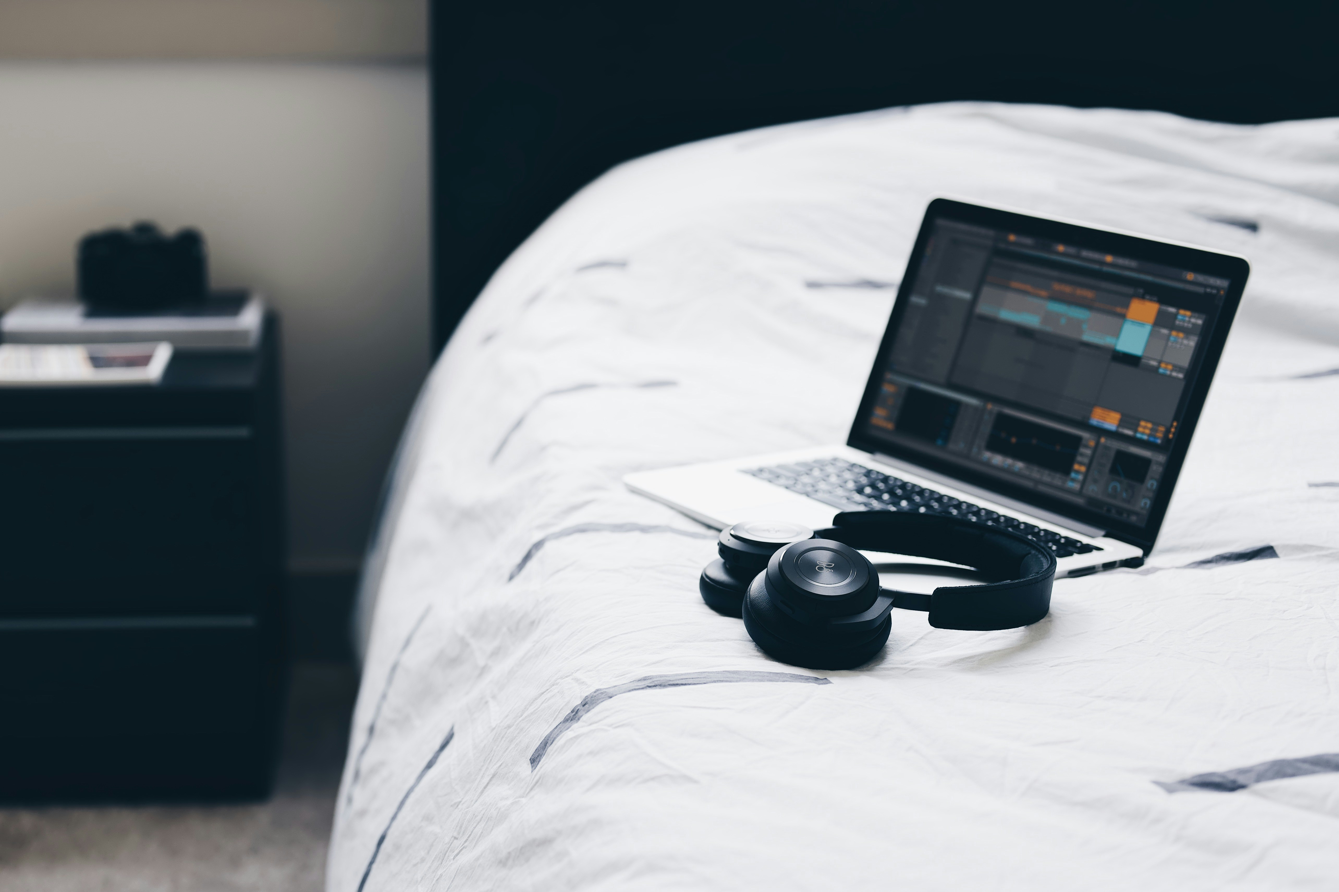 Laptop placed on Bed with Headphones - Music Production 101