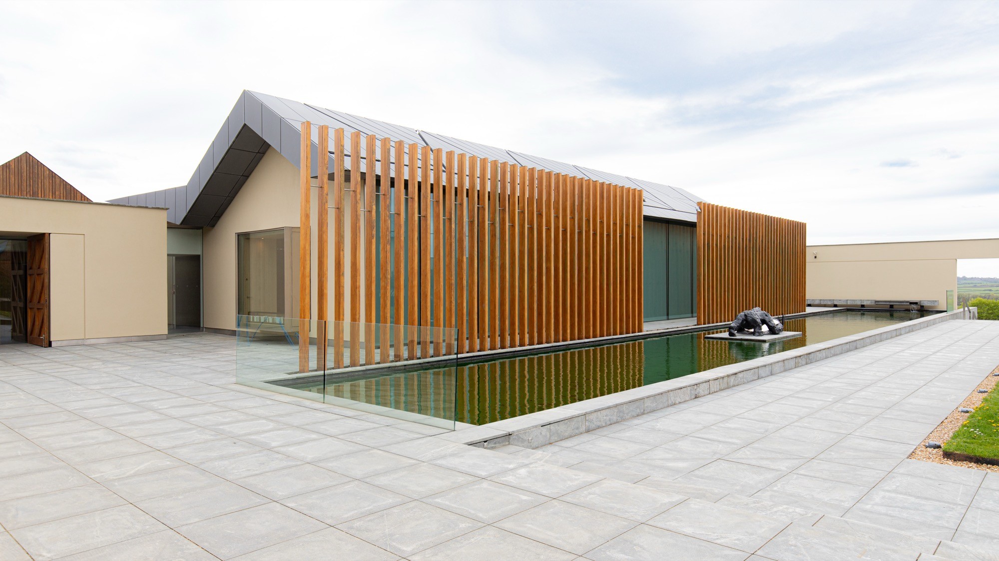 Two classic volkswagen beetles, one green, one cream.