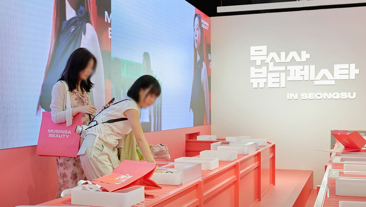 Visitors browsing brand tables inside the Musinsa Beauty Festa hall in Seongsu.