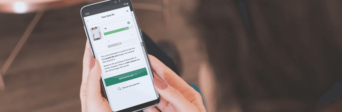 a woman looking at the Fit Finder results screen on a smart phone