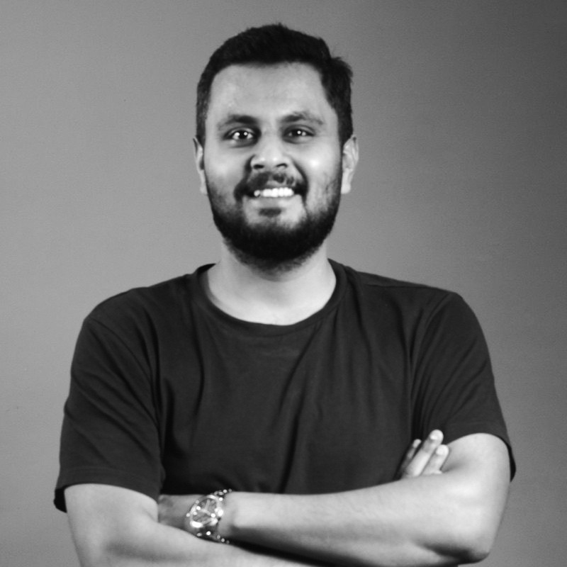 Black and white portrait of a smiling person with curly hair