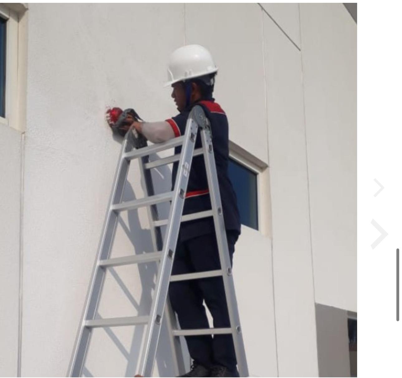 people sitting on chair in front of table while holding pens during daytime