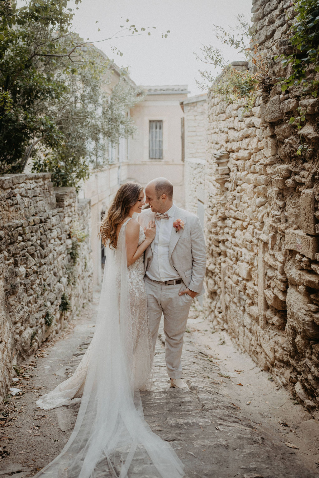 Couple embraces on a cobblestone path, captured by a photographer in Switzerland.