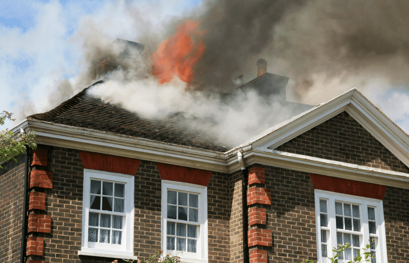 house on fire with flames coming from roof