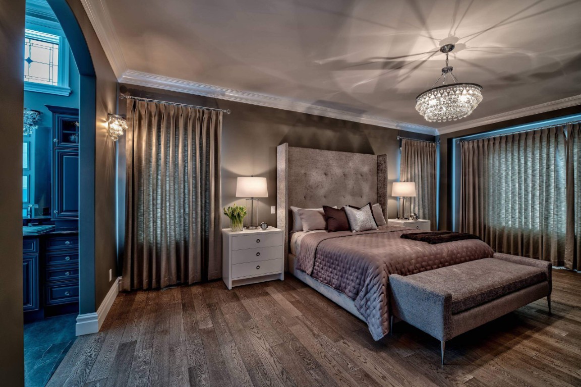 Image of Luxurious primary suite with plush furniture, elegant window coverings, and sophisticated interior design by KHD Homes.