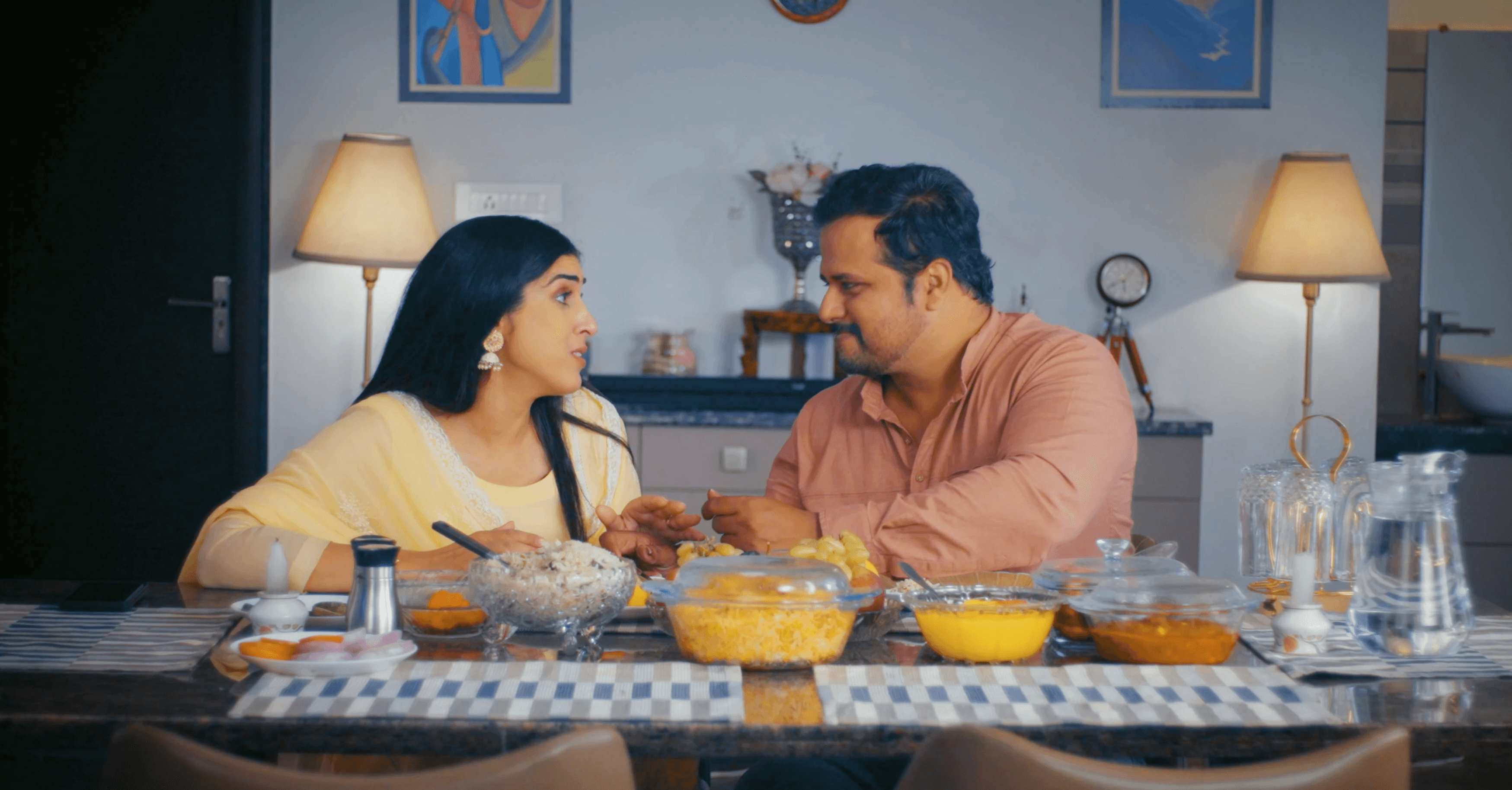 Couple sharing a meal at home in an ad film for Hungersate.