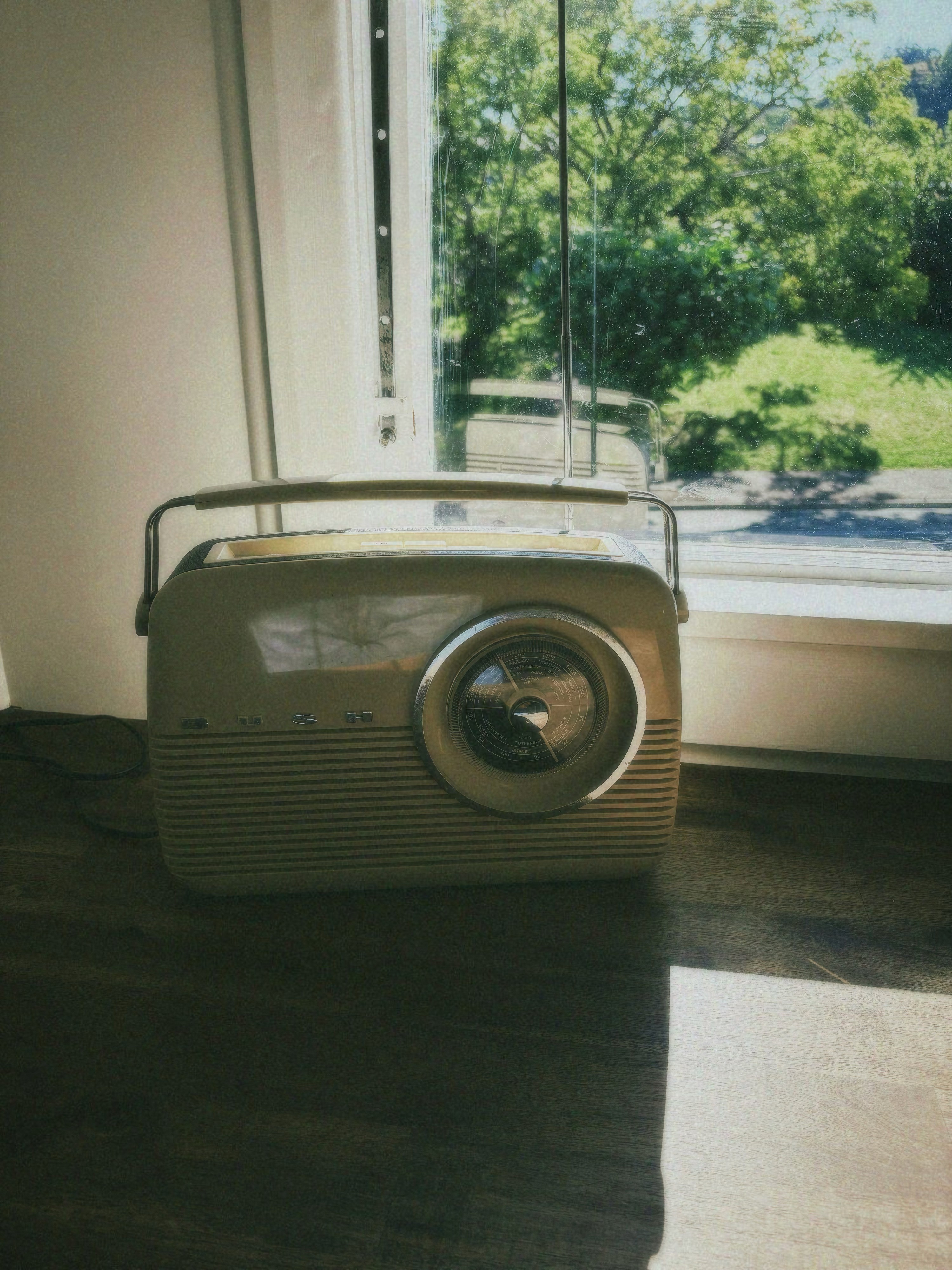 A close-up of a person wearing green-tinted glasses, with a serious expression and smooth skin.