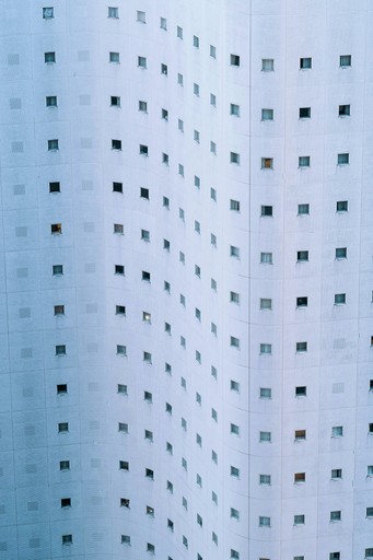 A modern building facade with many small square windows