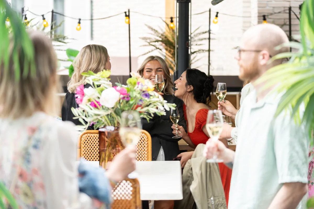 Girls laughing and enjoying themselves at a party.