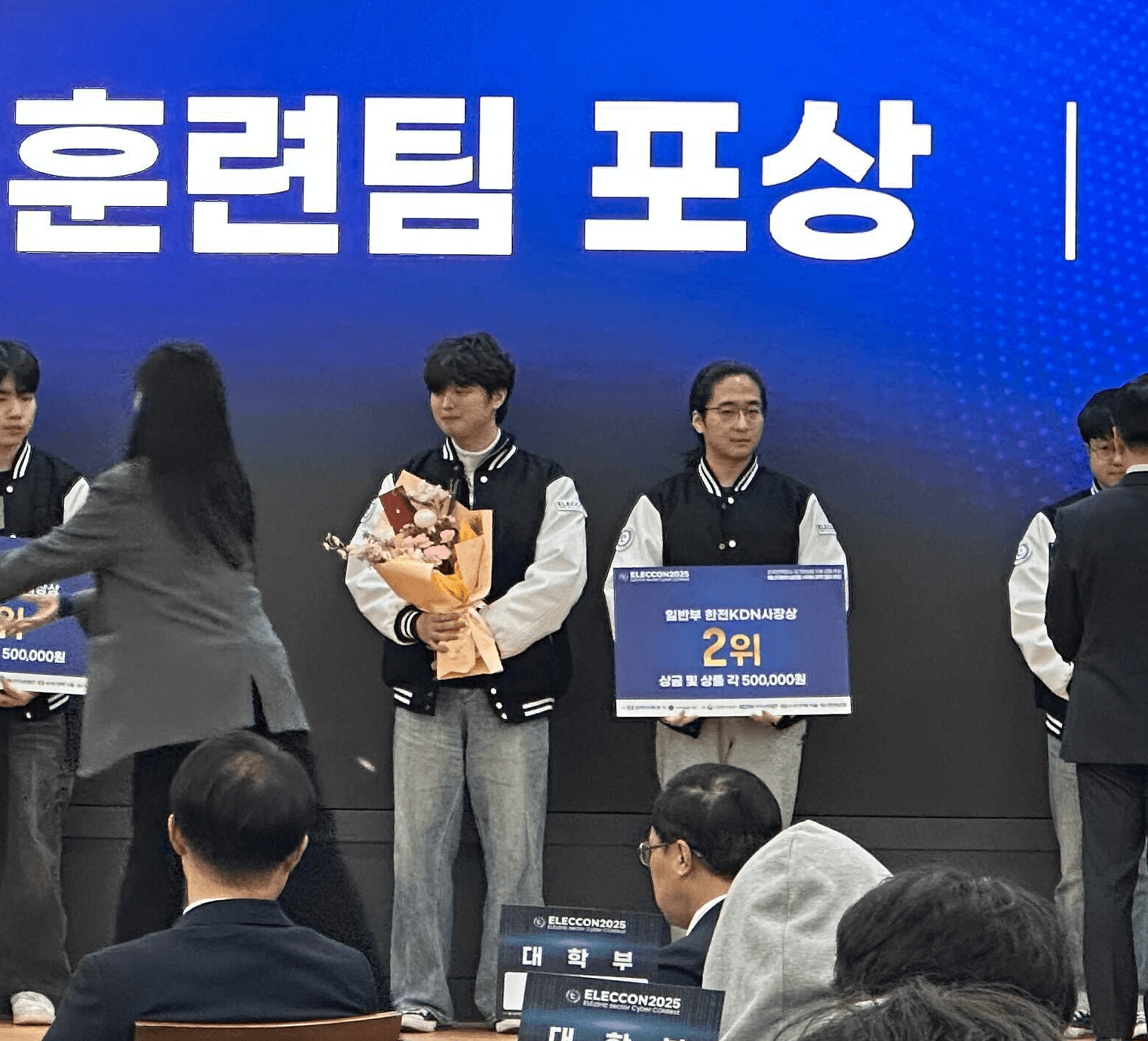 (왼쪽부터) 엔키화이트햇 소속 채하늘 연구원과 오승주 연구원이 일렉콘 2025 시상식에서 한전KDN사장상을 수상하고 있다. [자료: 엔키화이트햇]