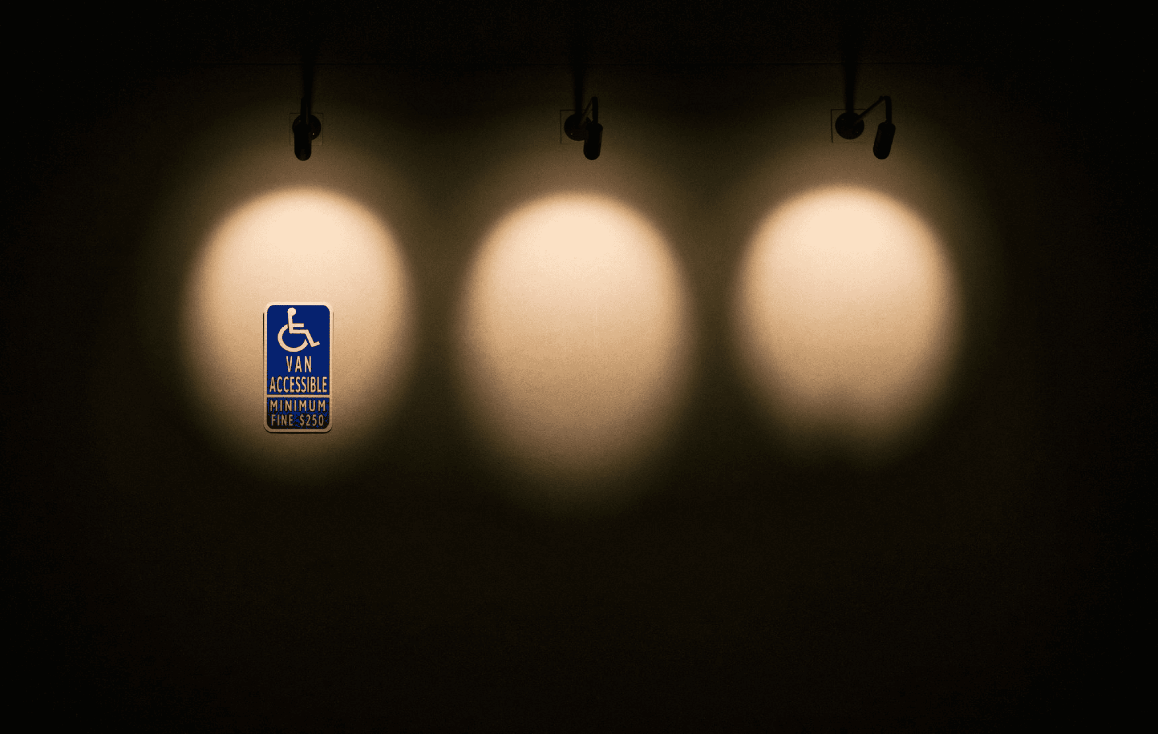A bright, illuminated sign mounted on a wall, casting a warm glow in the surrounding area.
