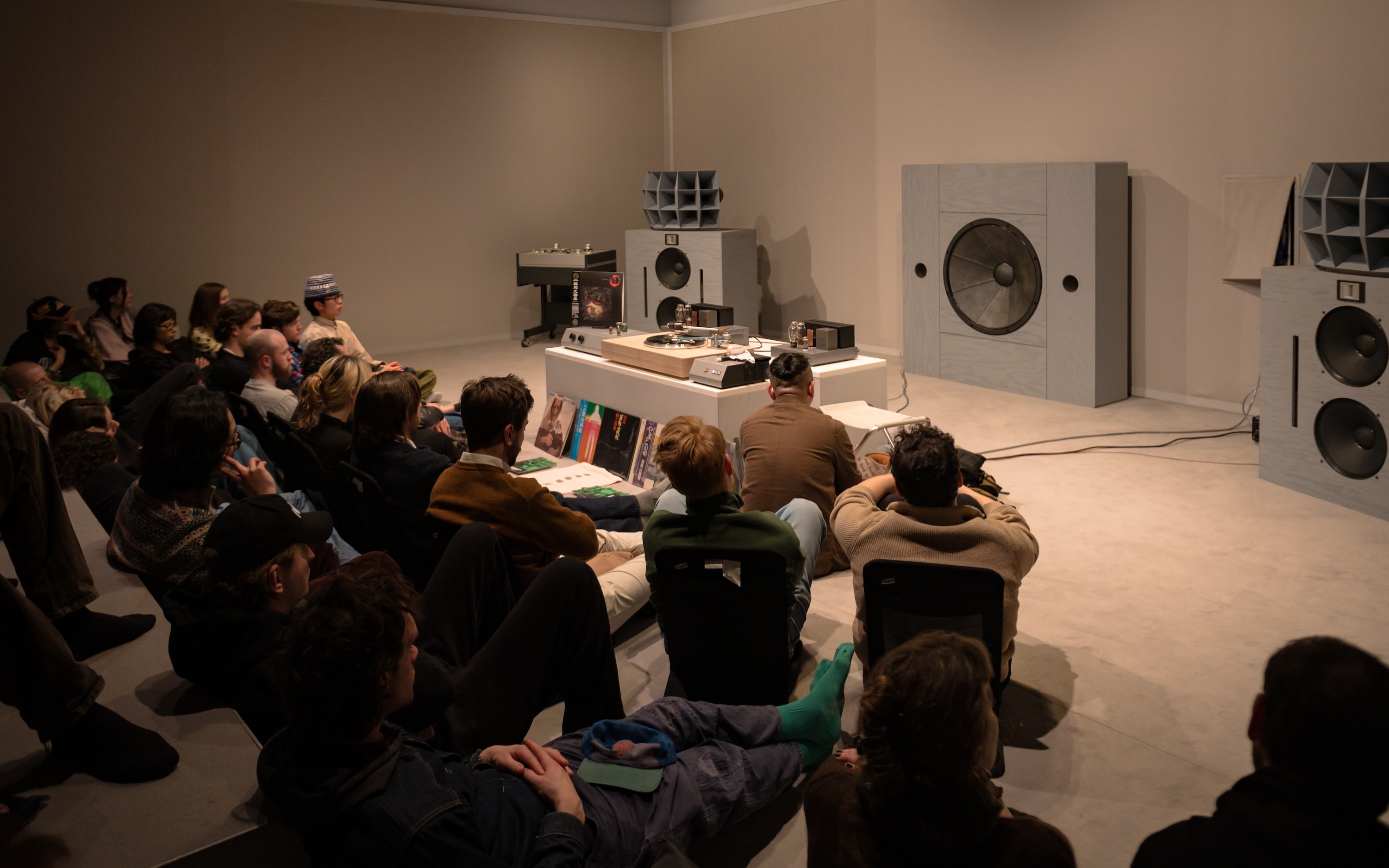 Audience at a listening session inside 180 Studios
