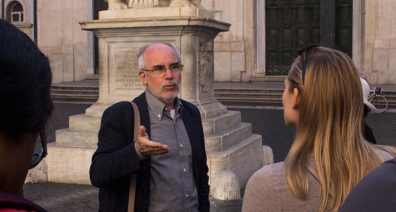 Lecturer taking to a student at a public site