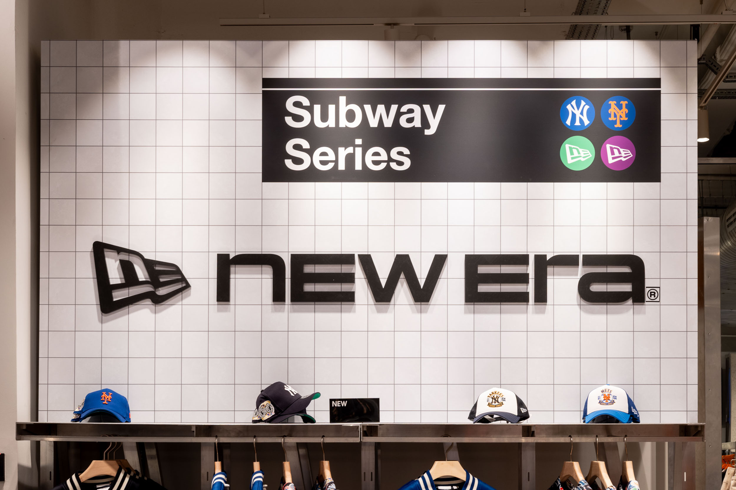 Retail activation signage and branded display wall featuring large-scale graphics, sports-inspired storytelling