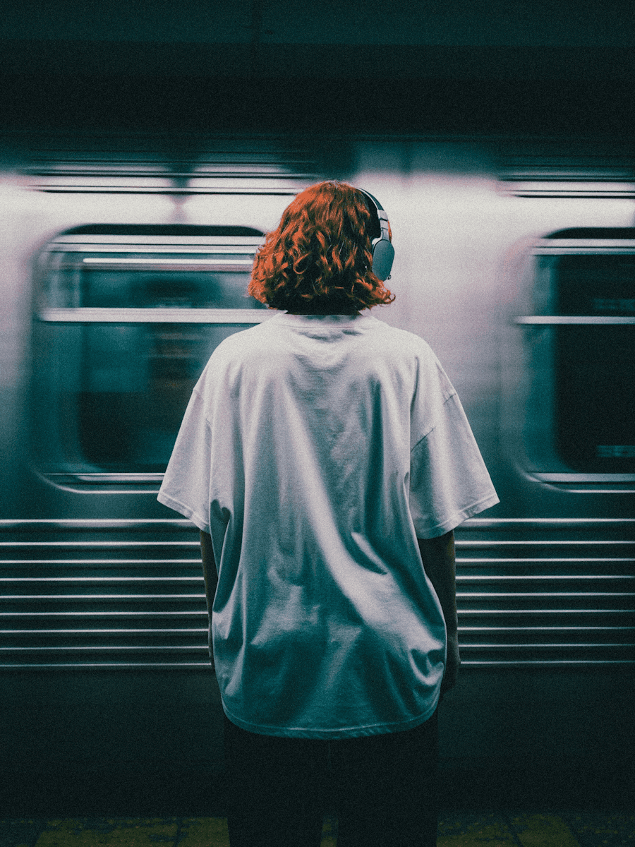 A woman in blue shots carrying a back pack while reading the map