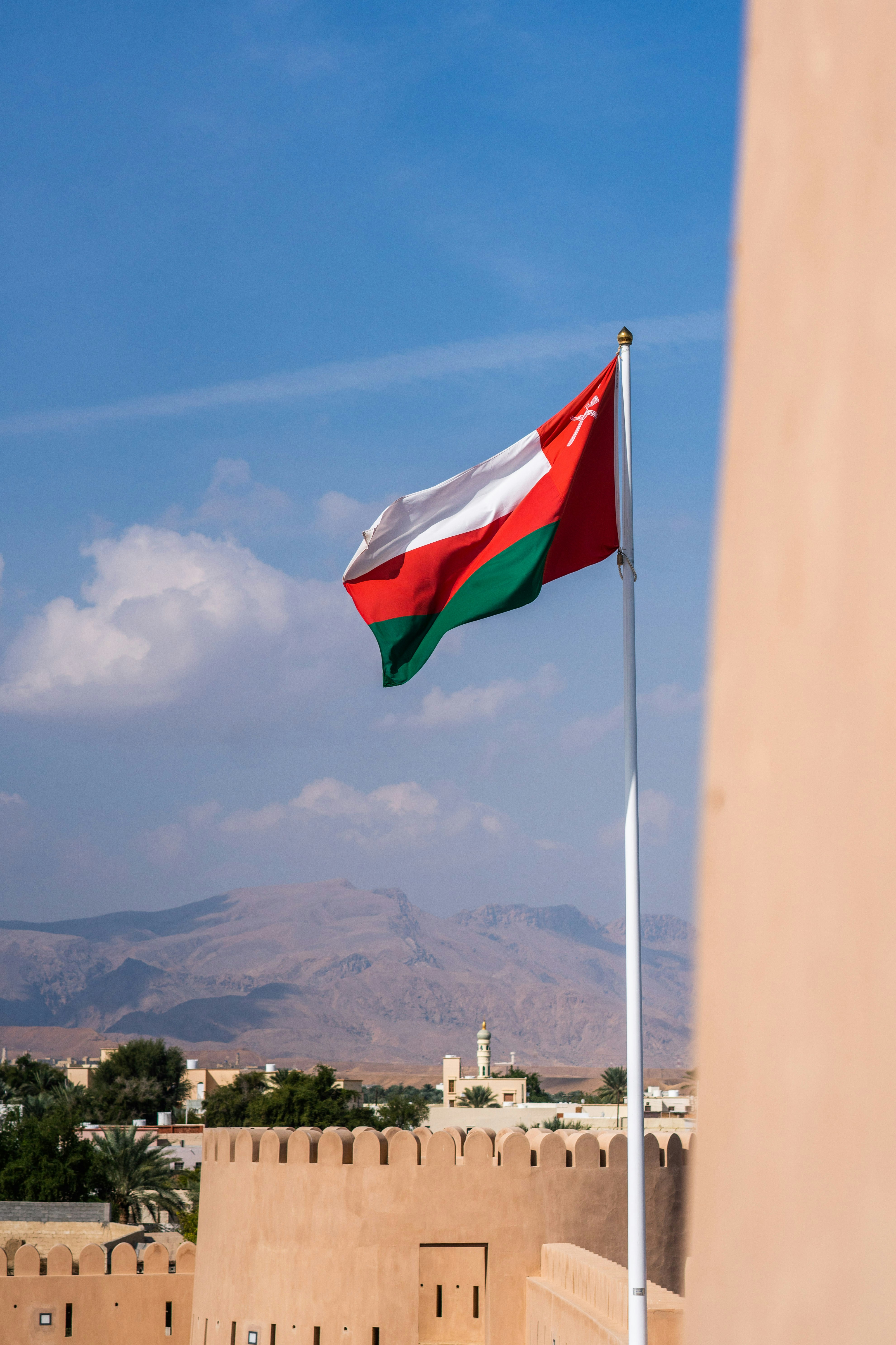 white red and green flag on pole during daytime
