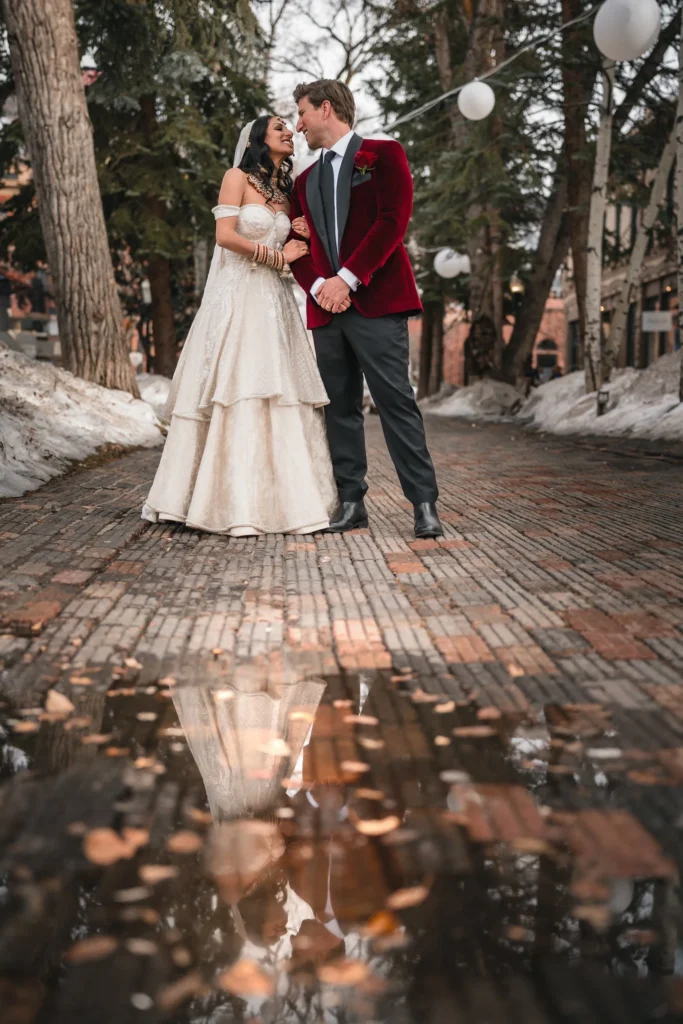 Bride and groom walking together in snow during T-Lazy 7 elopement Aspen