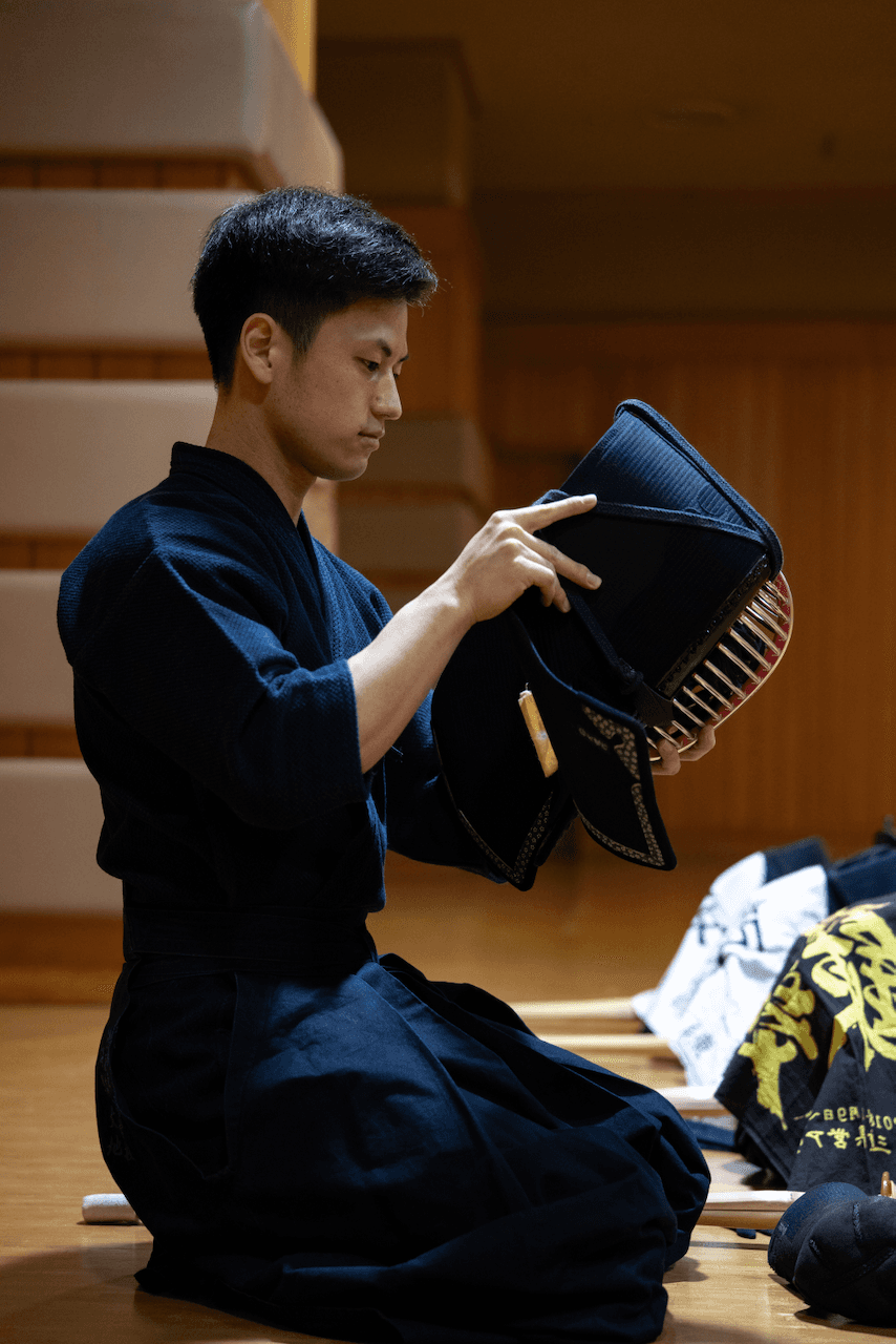 Kendo martial artist putting on gear