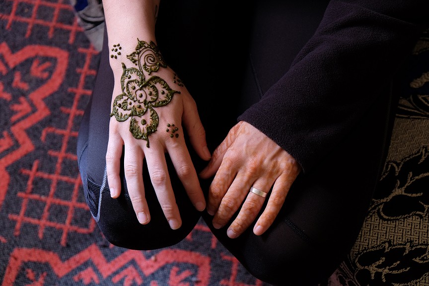 Lone tree silhouetted on a hill at sunset