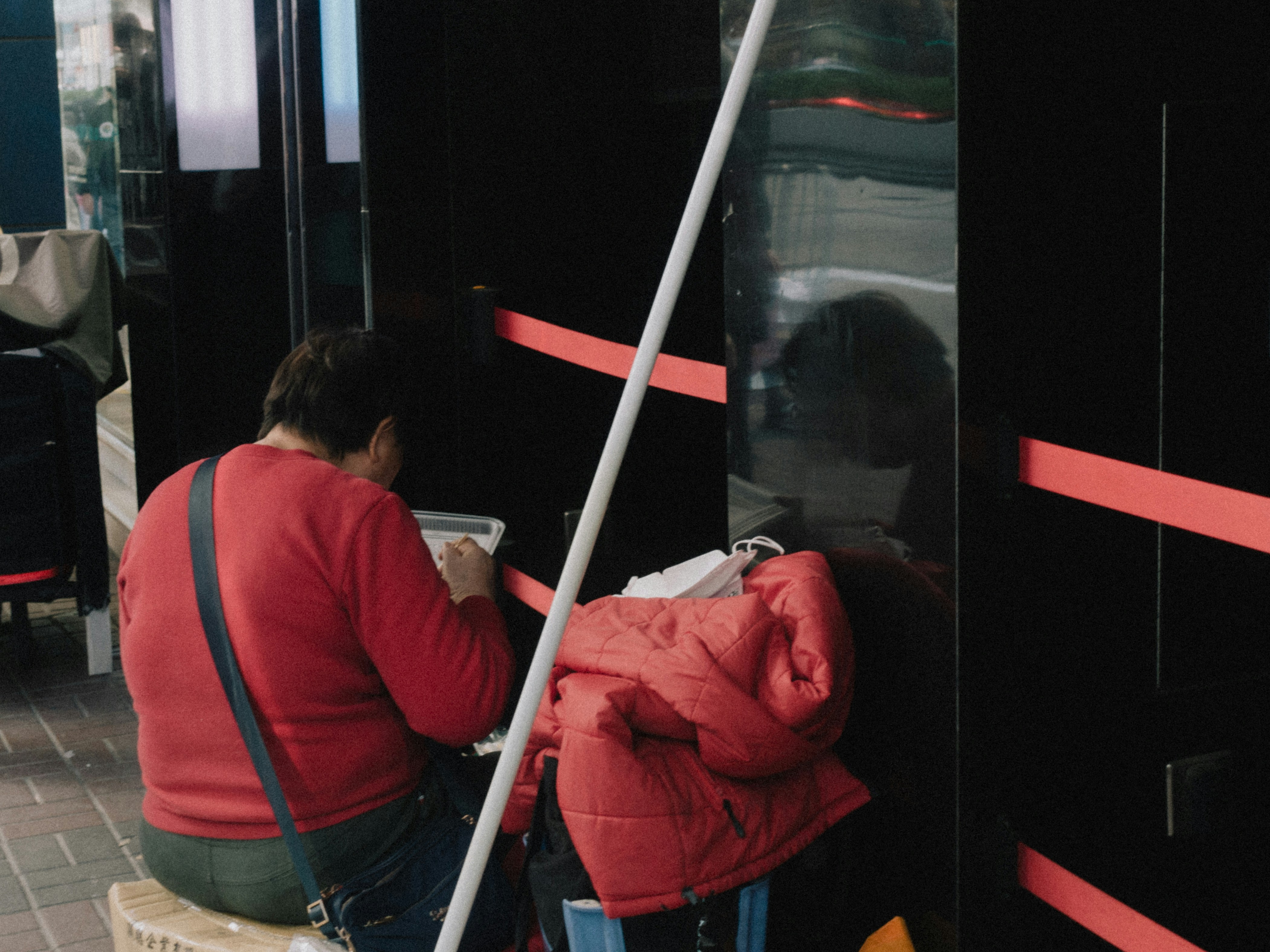 woman holding a phone and man looking at the phone. both are smiling