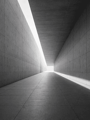 Monochrome architectural corridor with strong perspective lines, representing visibility, understanding and clarity.