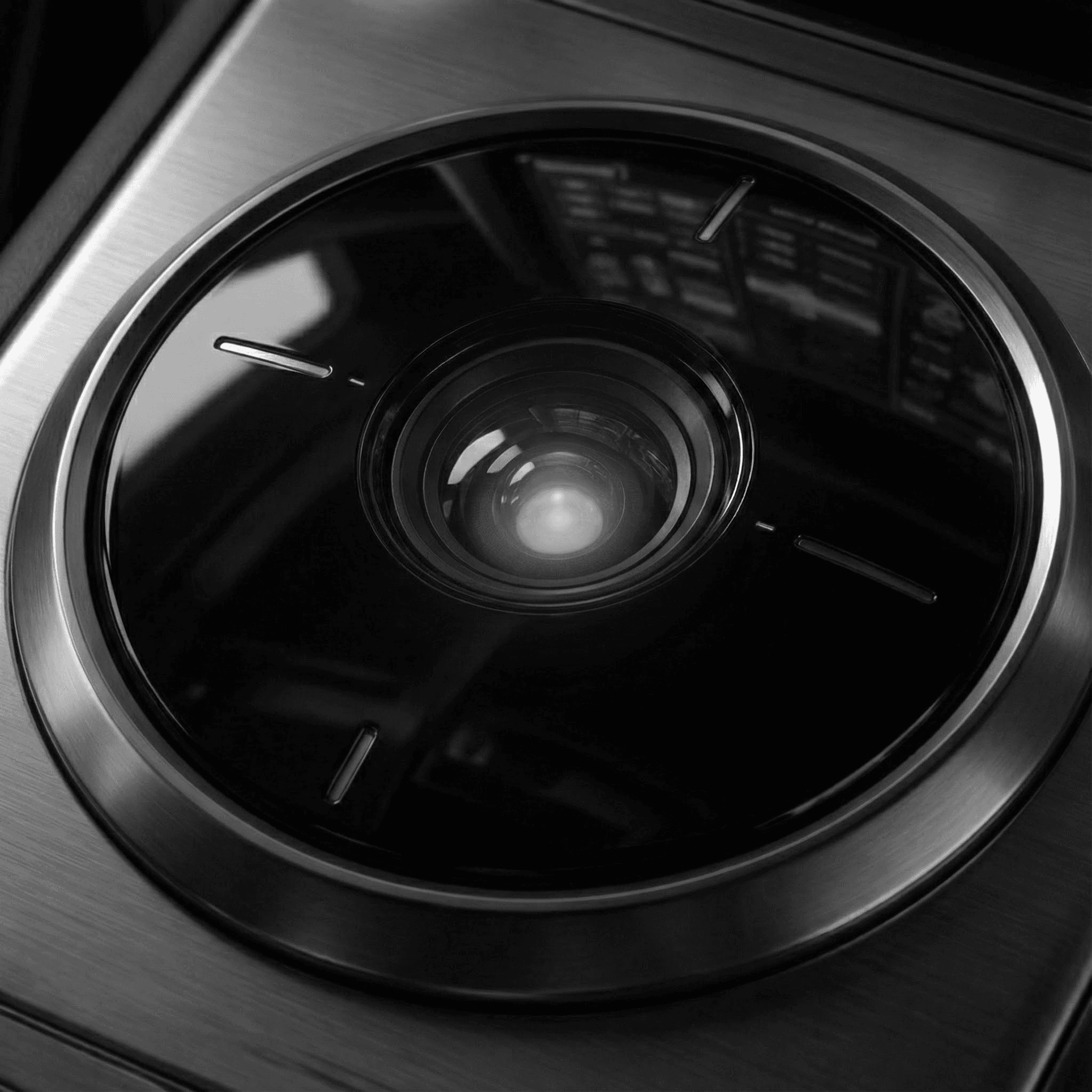 Portrait of a woman with straight long hair, in a dark t-shirt, set against a neutral backdrop.