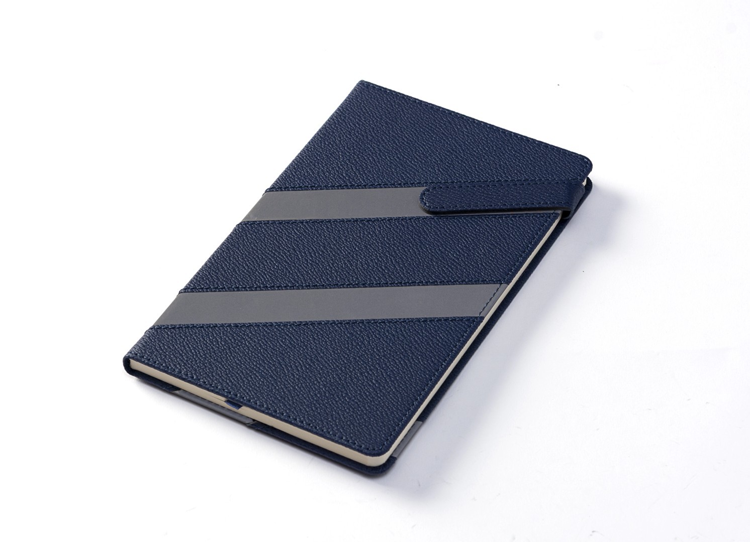 Angled view of closed blue notebook with textured finish.