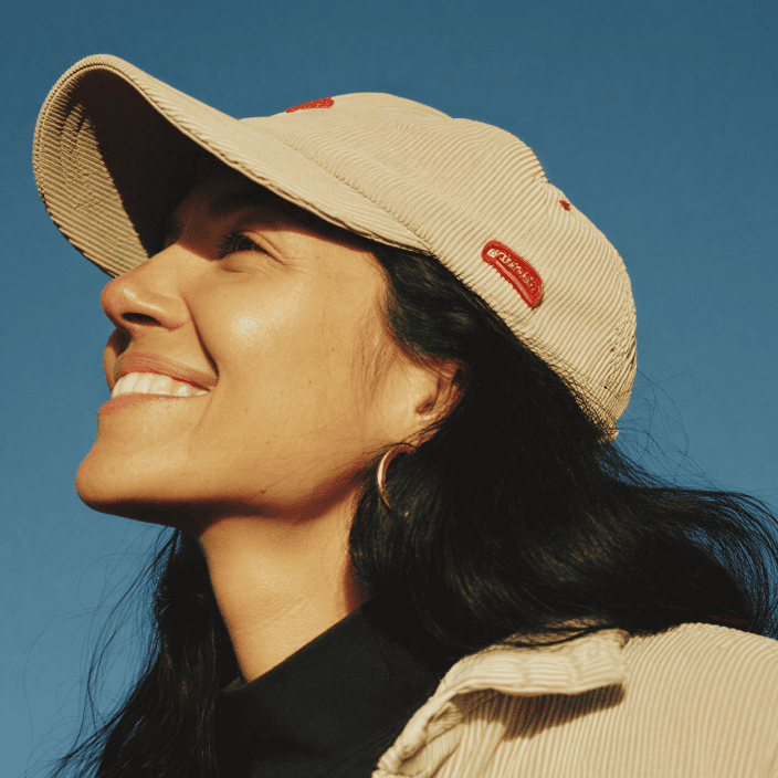 Asian woman in white turtleneck sweater with eyes closed