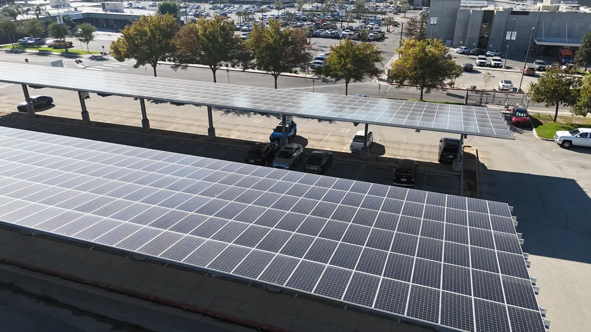 Drone view of solar carport rows beside office buildings at Sakata Seed in Bakersfield, CA