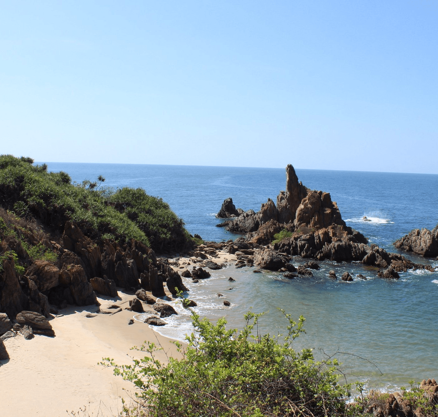 <img src="black-rocks-seashore.jpg" alt="A rugged sea shore with dark black rocks and gentle ocean waves washing over them">