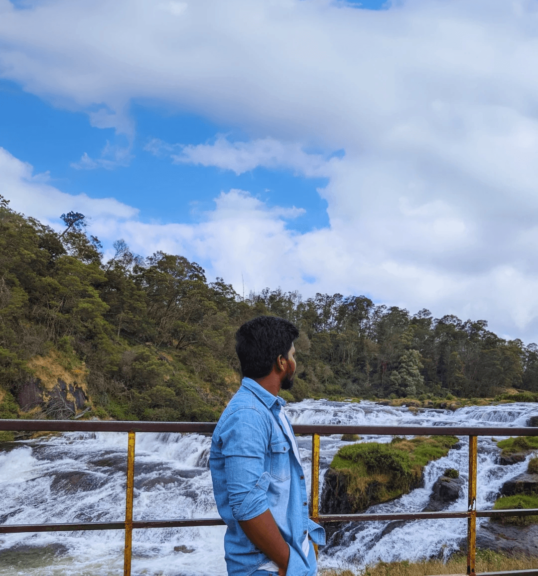 Two people talking on a rooftop at sunset