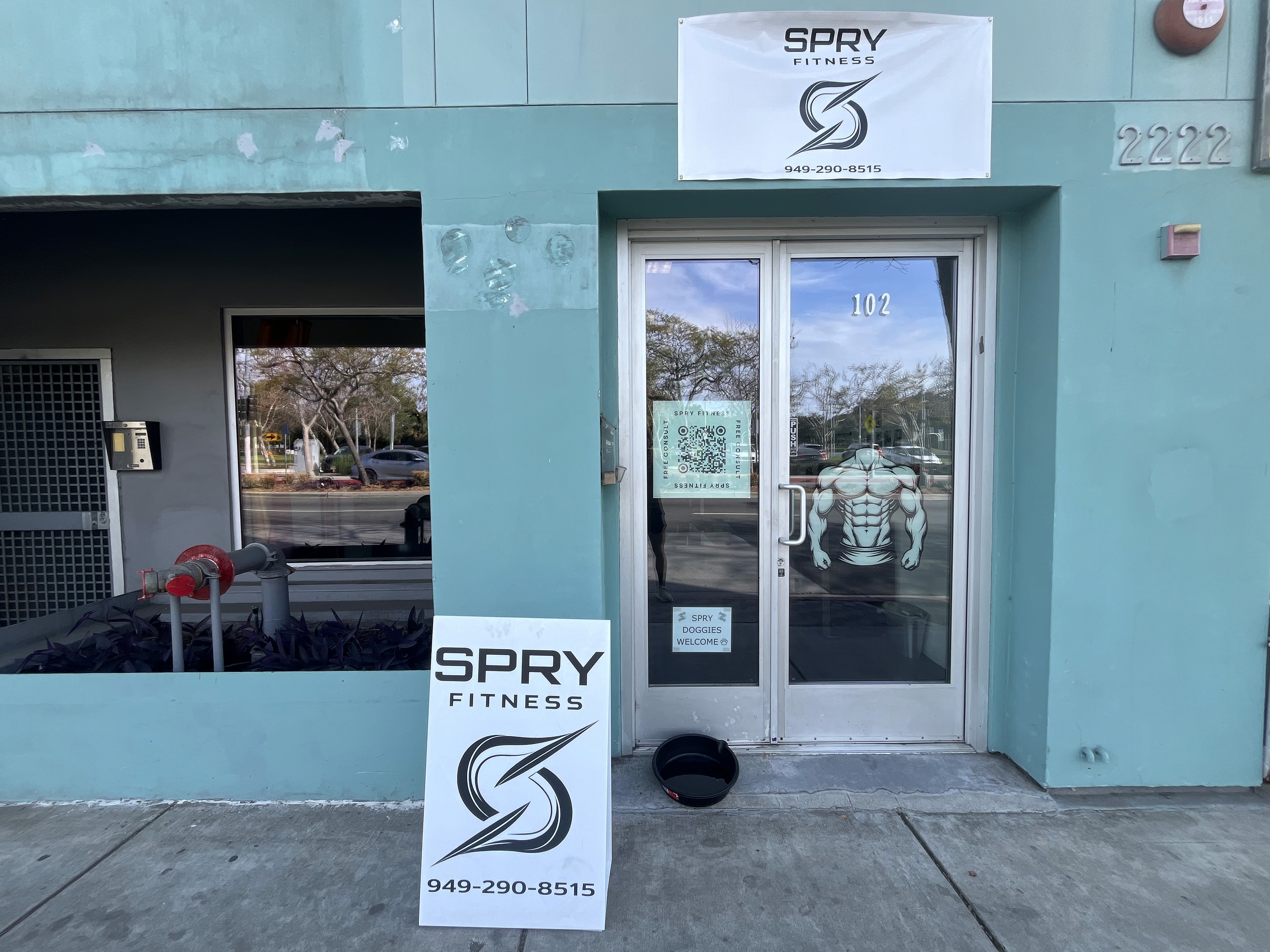 Rachel, personal trainer, looking to the side confidently in a fitness studio