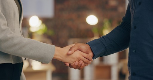 Closeup of business handshake symbolizing partnership, trust, and onboarding with EU compliance experts.