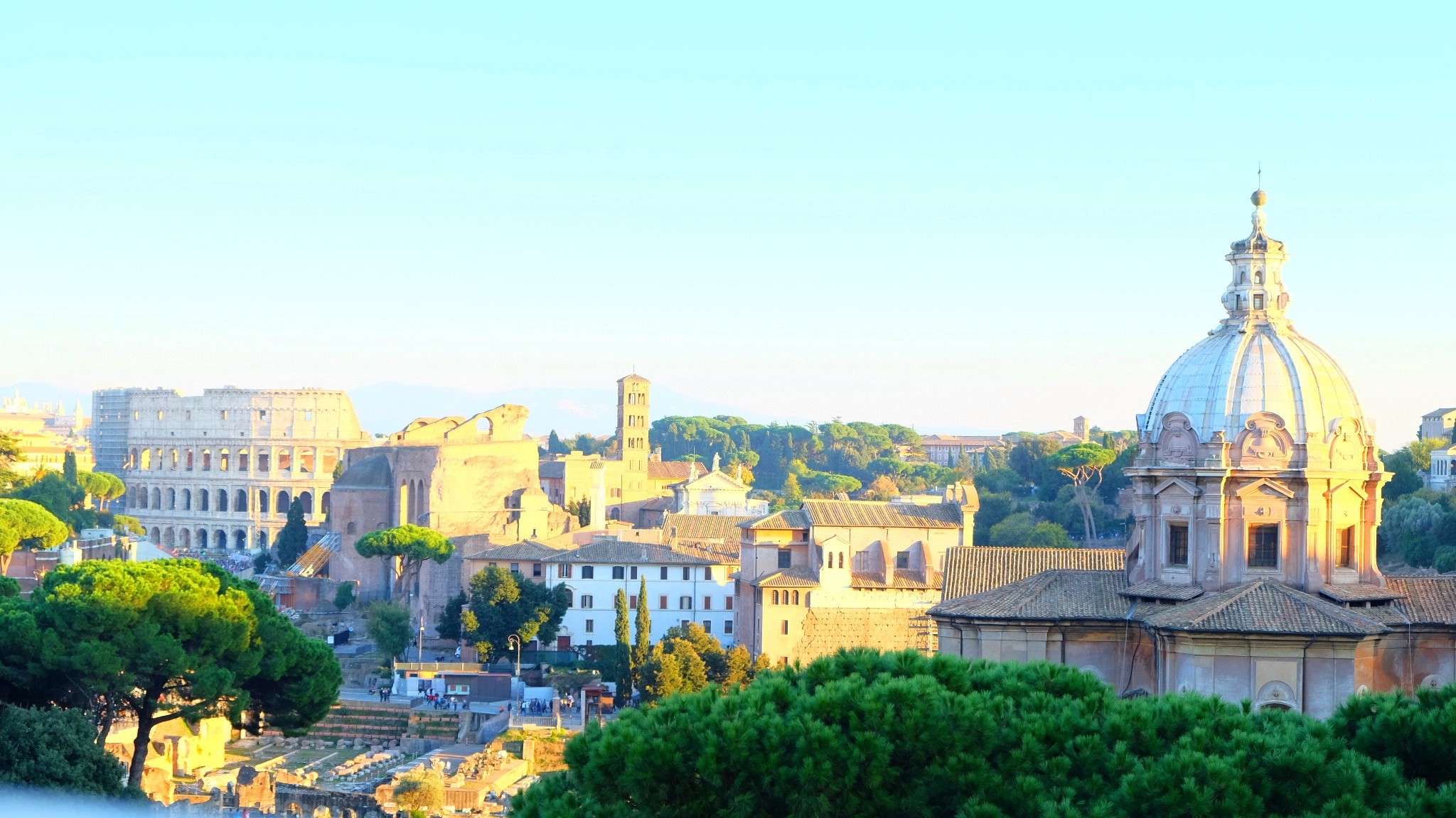 Two gold wedding rings rest atop a soft, textured fabric with a subtle pattern. The rings shine under gentle light, evoking themes of love and commitment.
