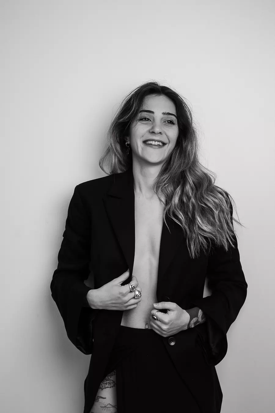 Potrait of a woman with curly hair smilling towards camera