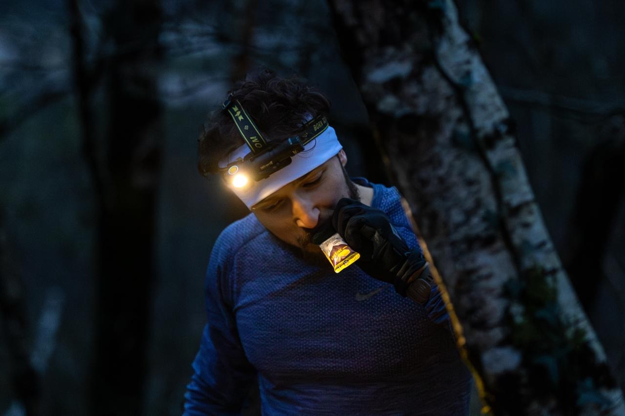 Trail runner eating during it's training by night