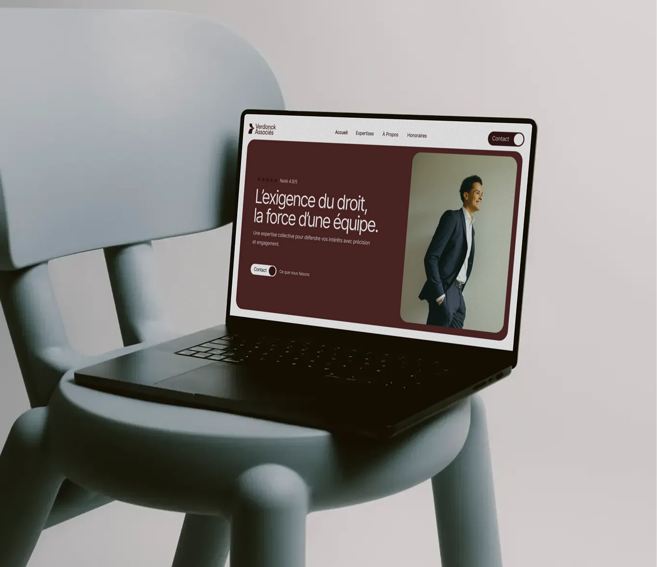 Ordinateur Apple Macbook sur une chaise bleu avec le site Verdonck Associés