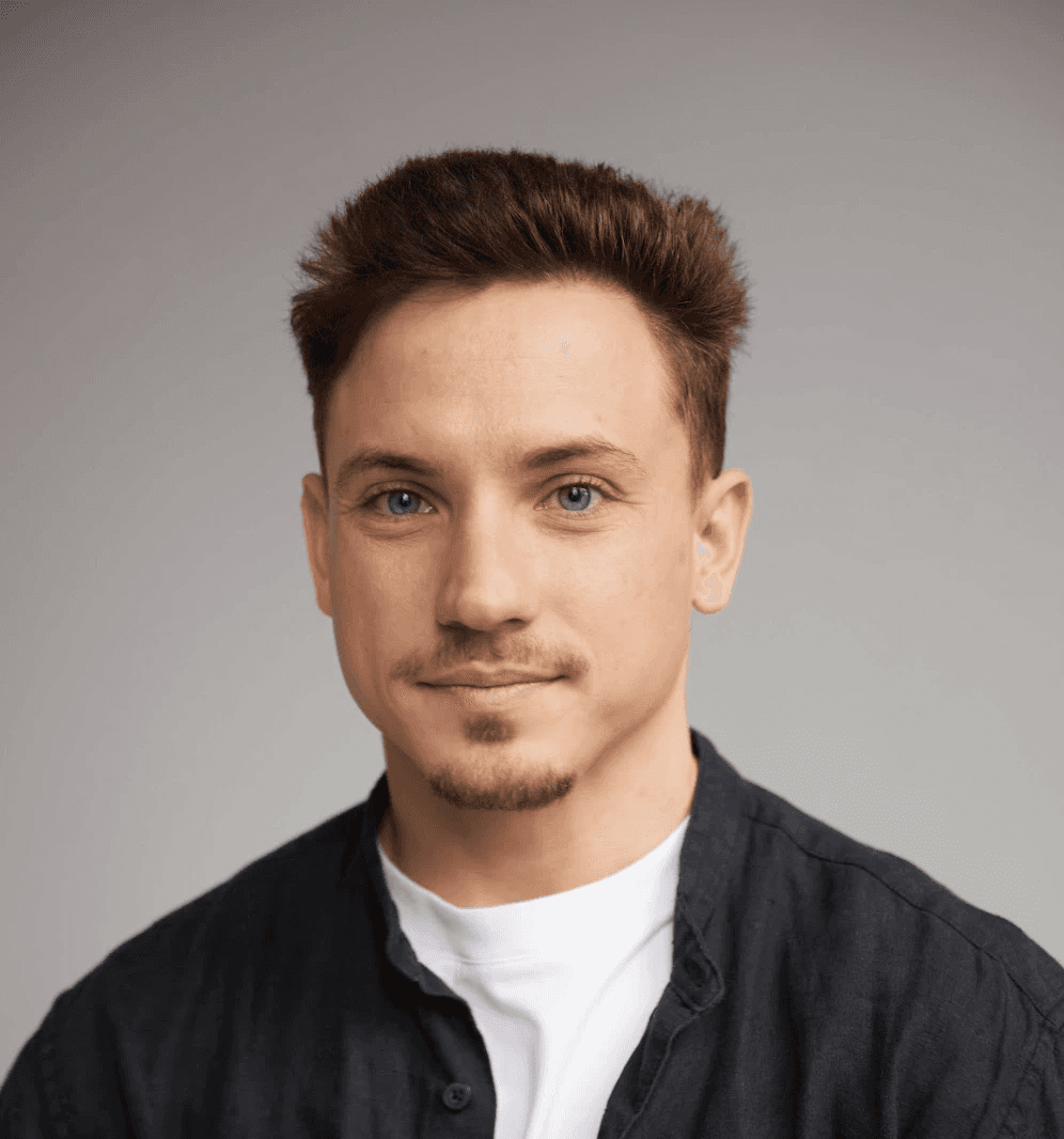 smiling woman sitting on grass during daytime