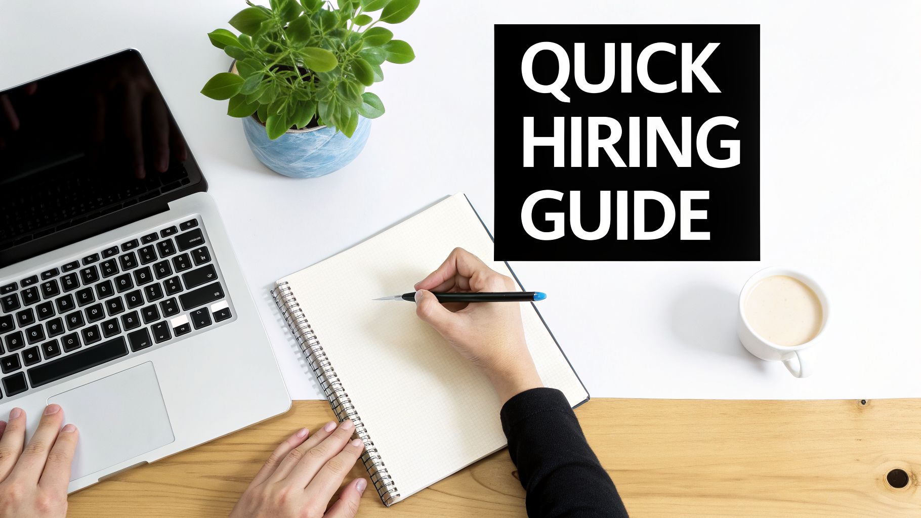 Overhead view of a person writing in a notebook on a desk with a laptop and a 'Quick Hiring Guide'.