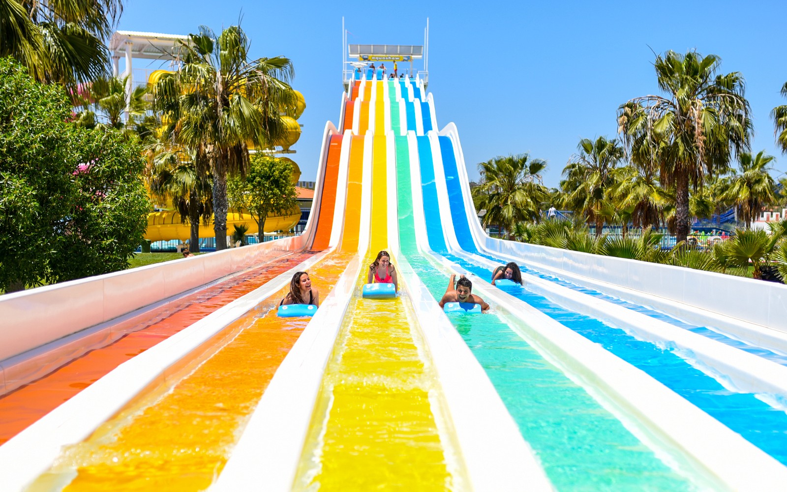 Visitors enjoying colorful water slides at Aquashow Park.