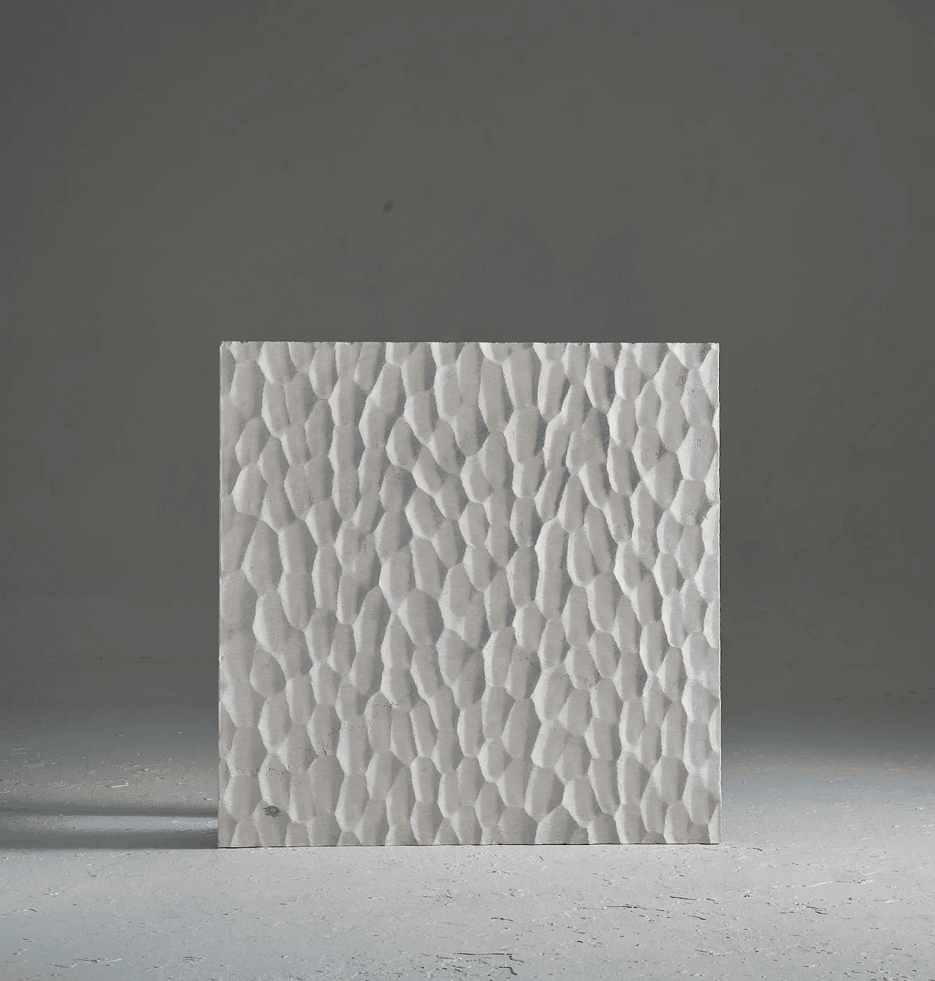 Carved marble surface study inspired by Japanese Naguri woodworking, featuring rhythmic chisel-like marks and repeated relief patterns.