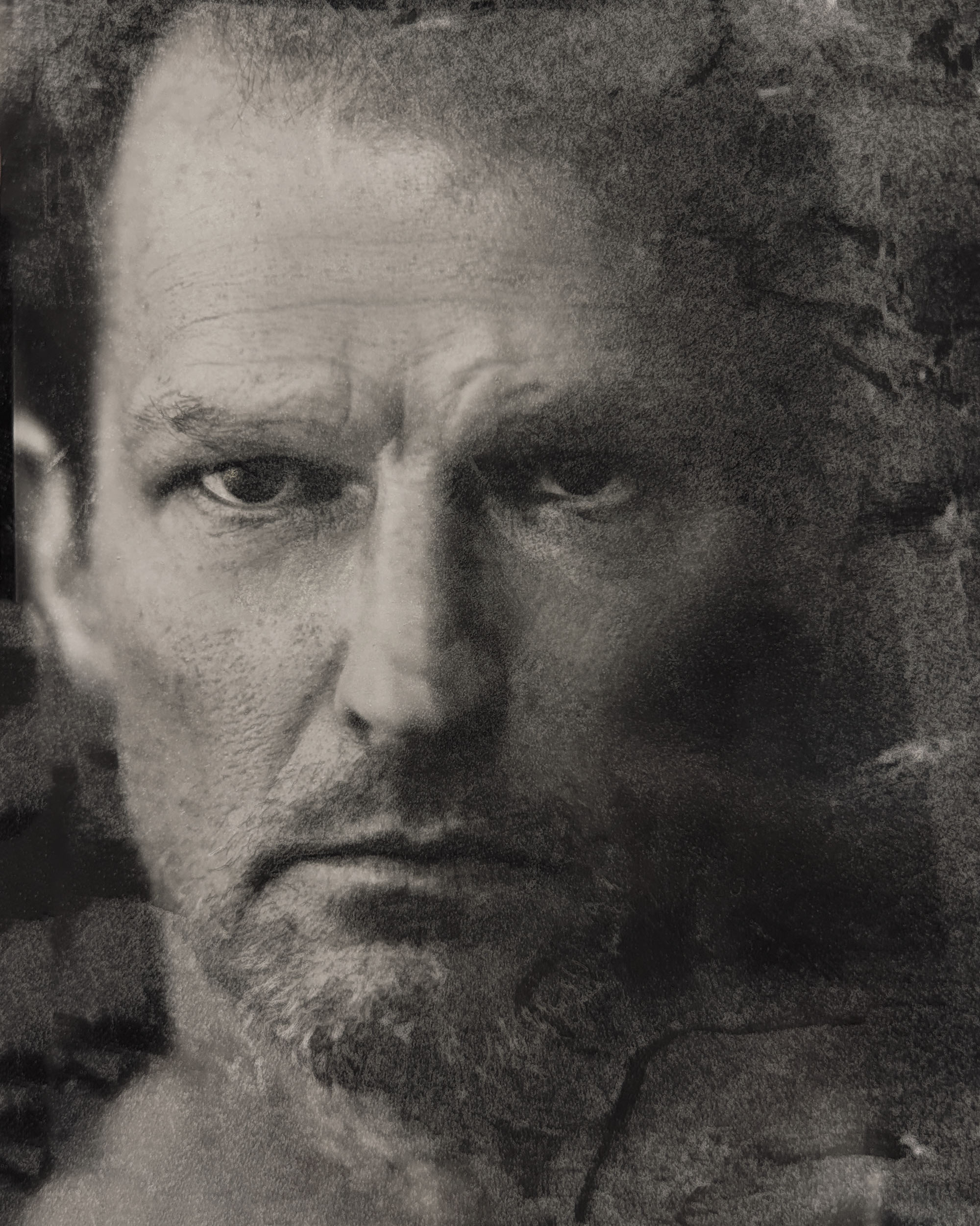 Black and white 4x5 direct positive portrait of a man staring at camera.