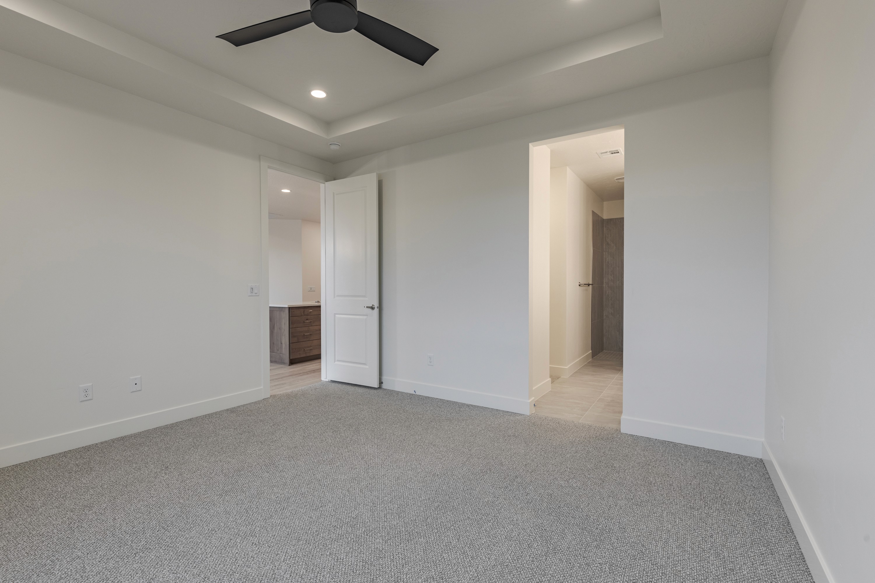 Master bedroom in the Painted Sands twin home in Hurricane, Utah emphasizing spacious layout and neutral finishes.