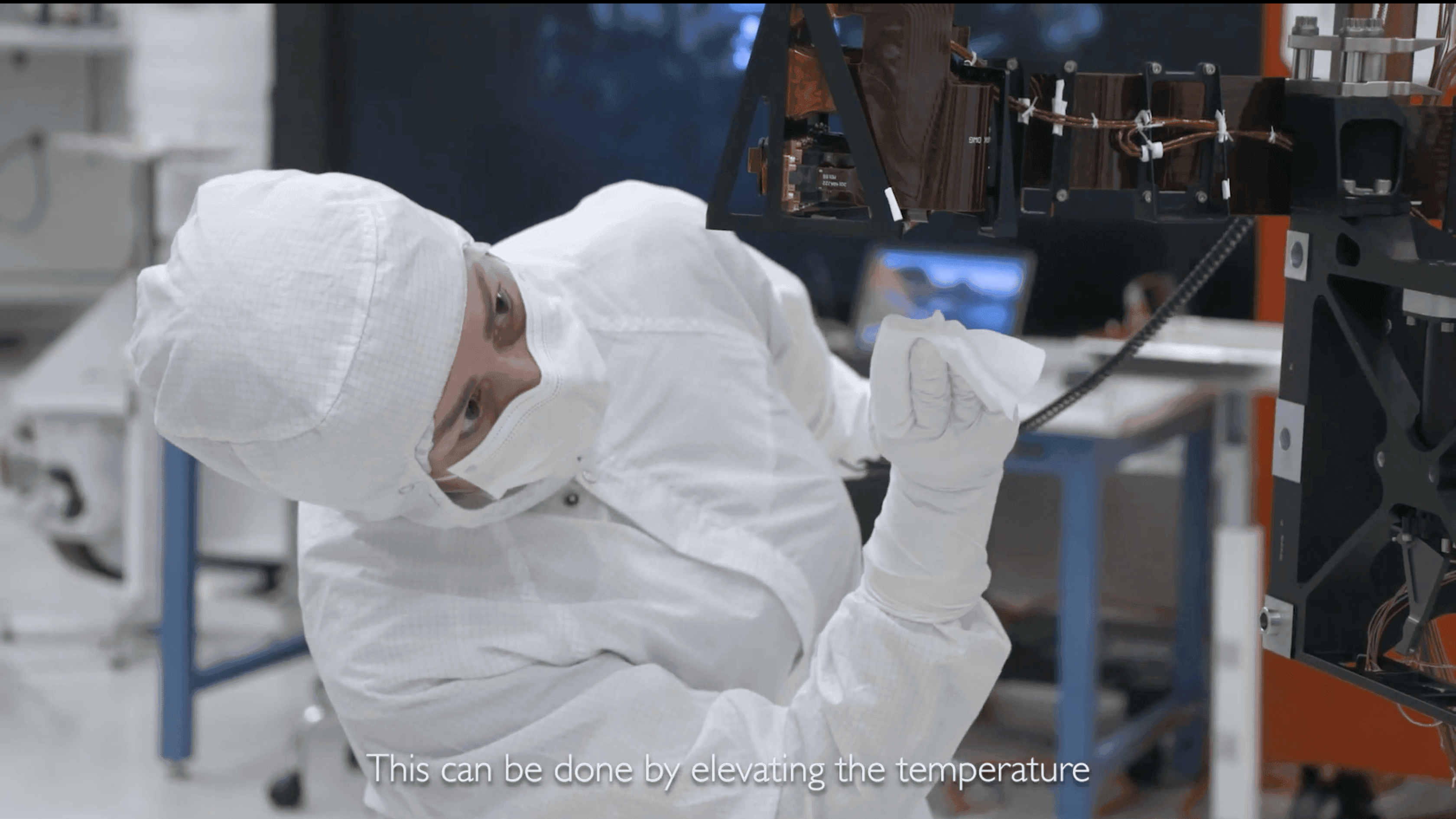 A member of the Planetary Protection team cleaning hardware on the Mars 2020 rover