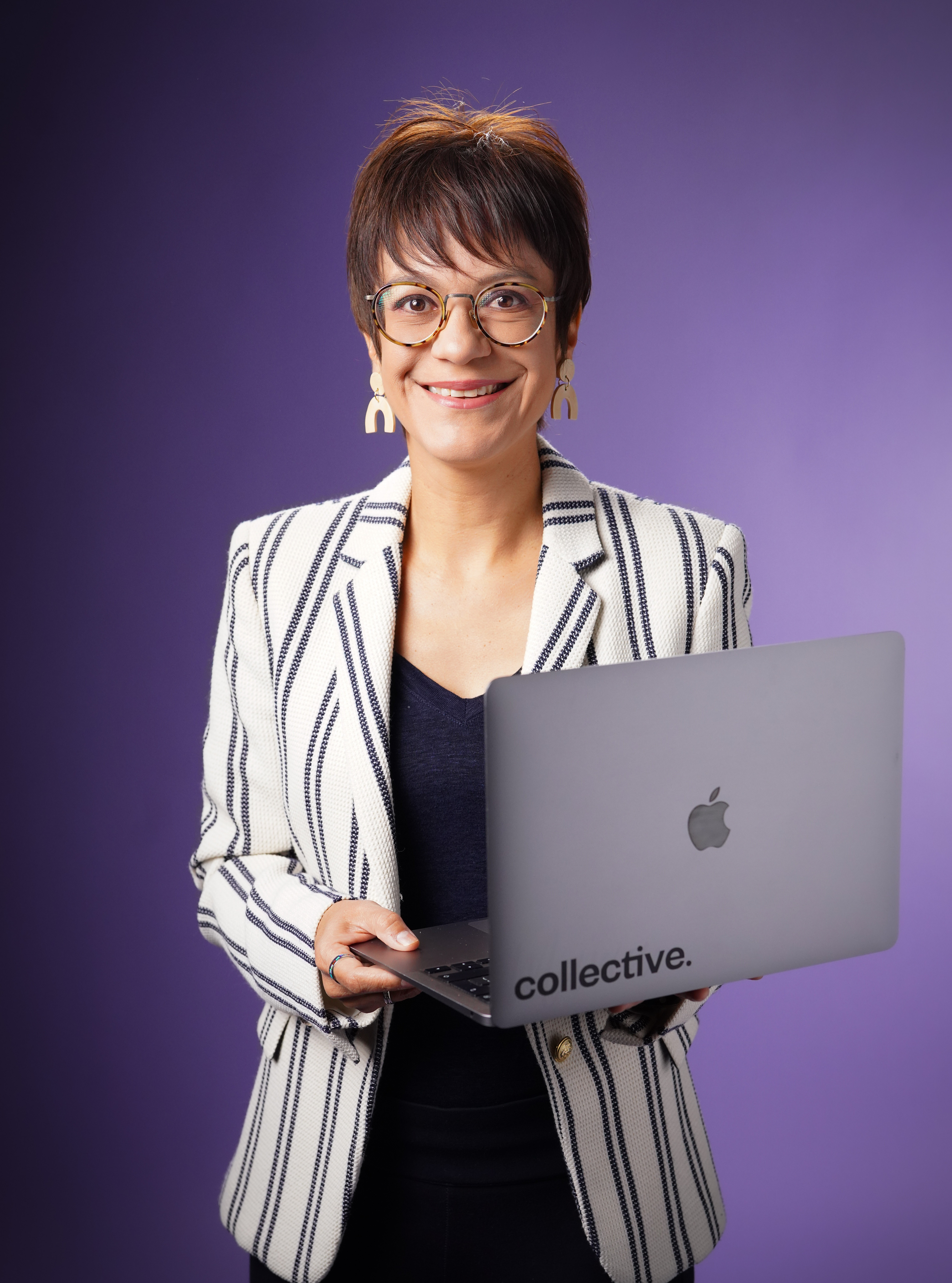 A group of focused colleagues gathered around a laptop, deeply engaged in a discussion or presentation