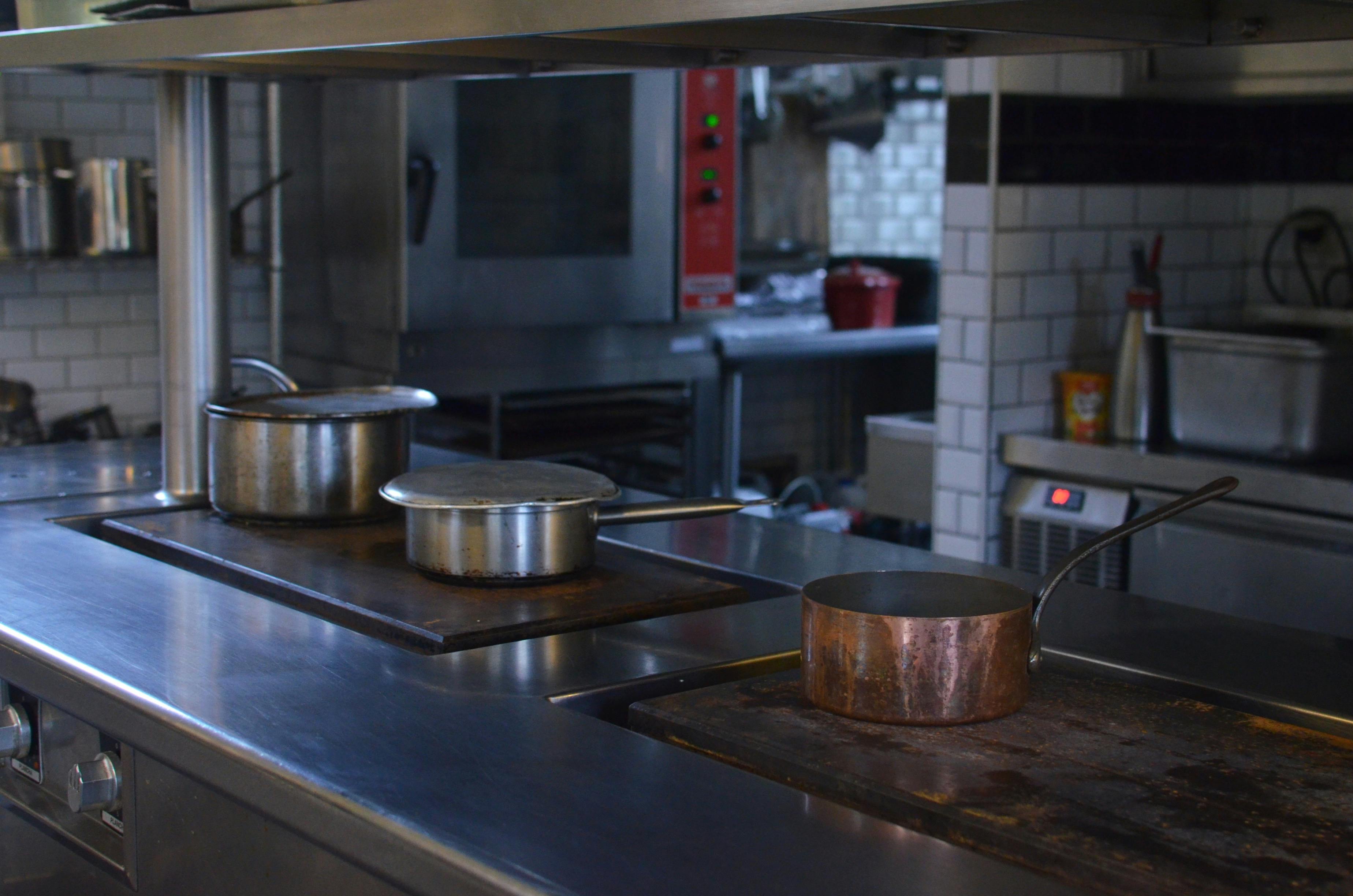 a man standing in a kitchen preparing food